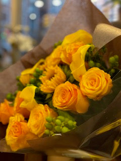 yellow calla lilies, and mingled hypericums along with yellow and orange roses