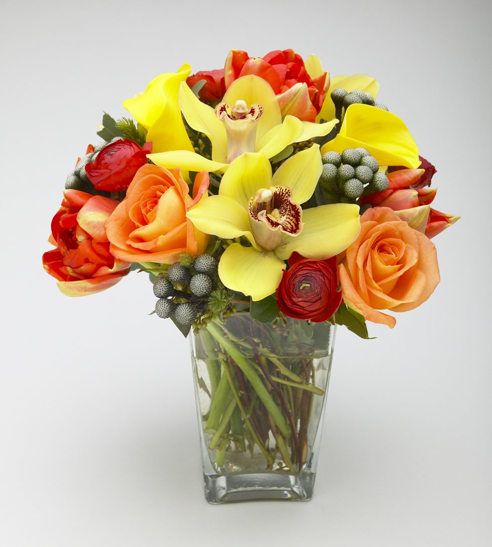 Tulip bouquet with orchids, roses, and berries in a vase