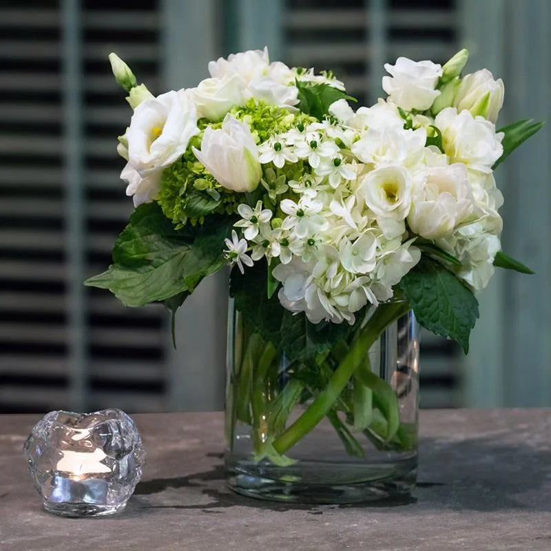 light spring arrangement is made with of all white roses, hydrangea, lusianthus